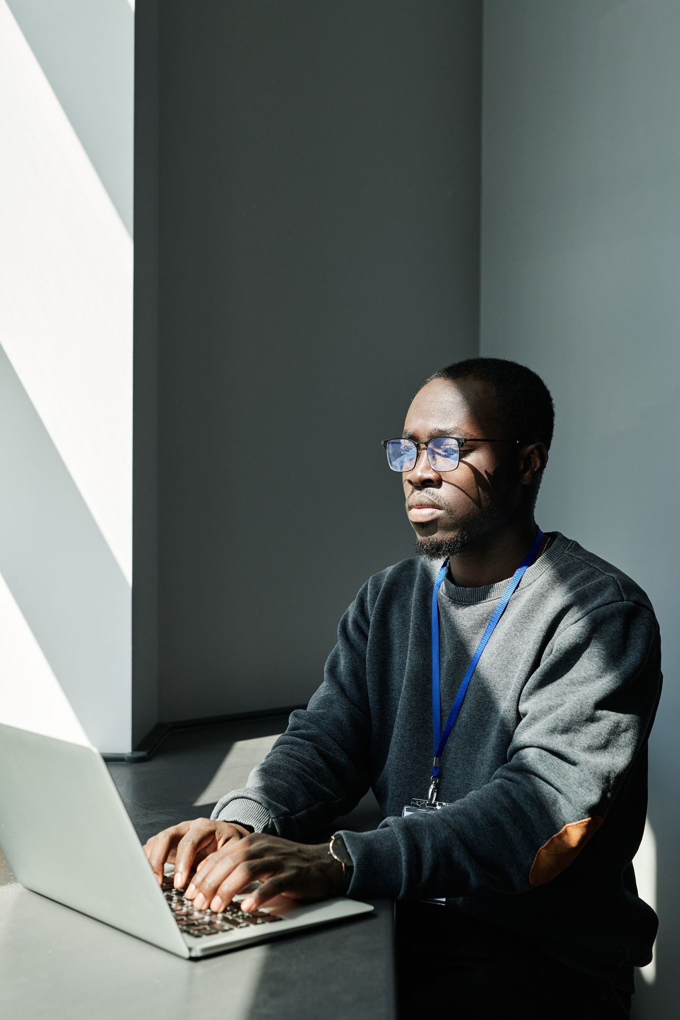 A person working calmly at a laptop in natural light