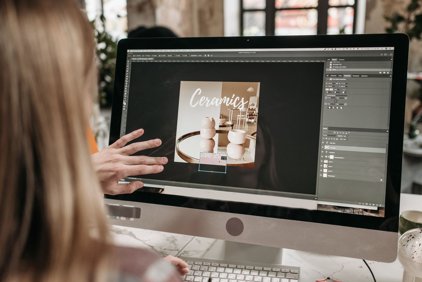 A designer reviewing a website layout on screen with a customer