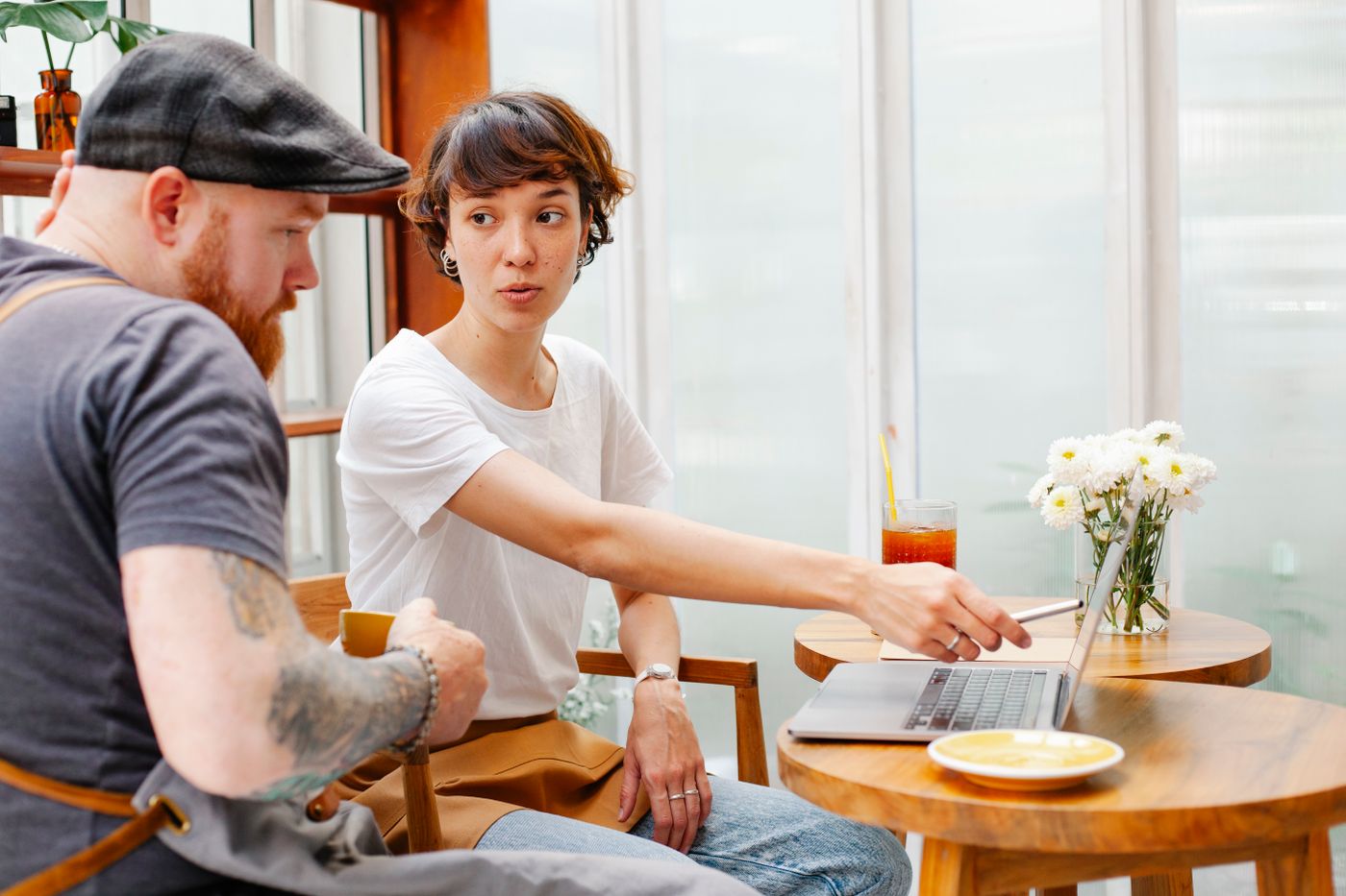 A freelancer and an AltaGrade specialist working together over a laptop